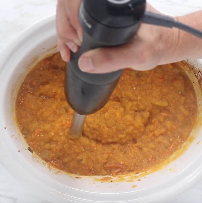 Butternut Squash Soup being pureed with an immersion blender. 