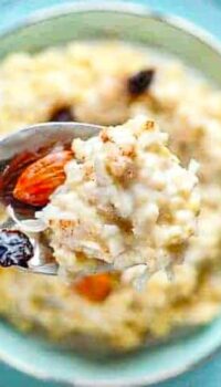a spoon of millet porridge with almonds and raisins on a spoon.