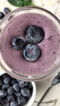 blueberry smoothie with frozen blueberries on top