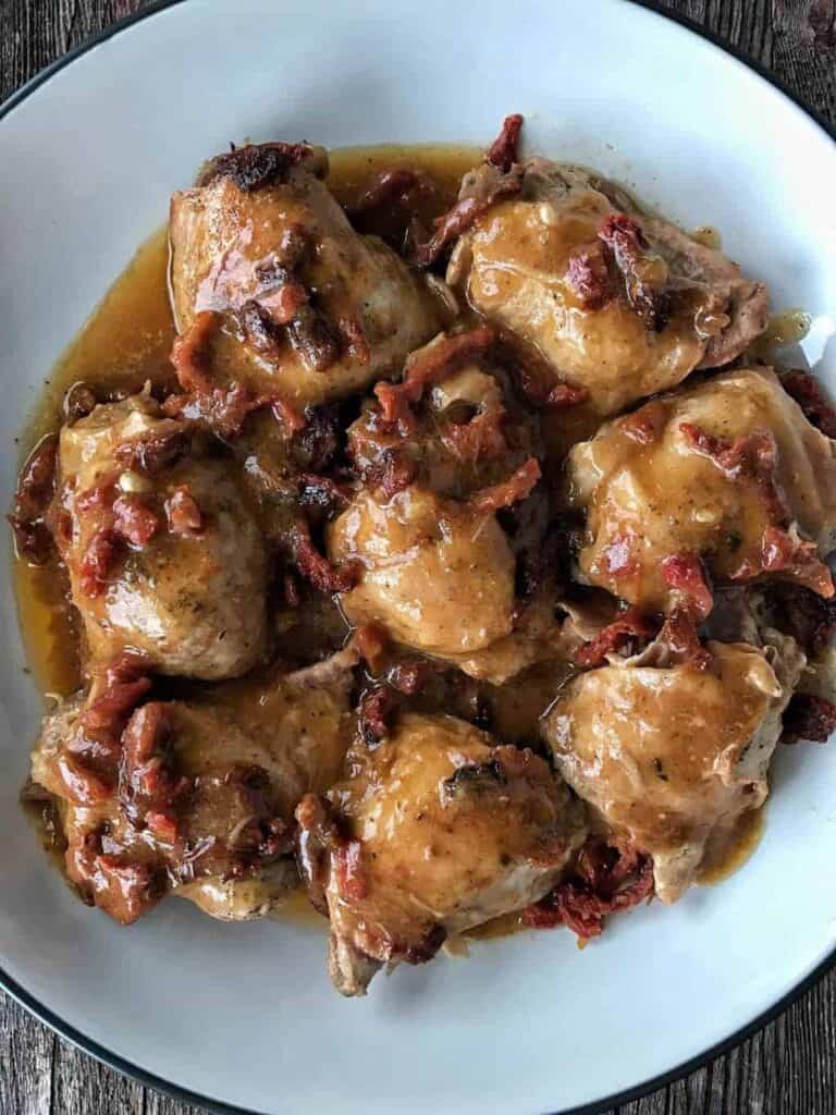 a white plate with chicken