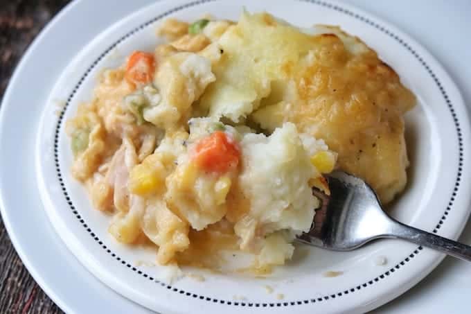 mashed potatoes, carrots, chicken and corn on a plate