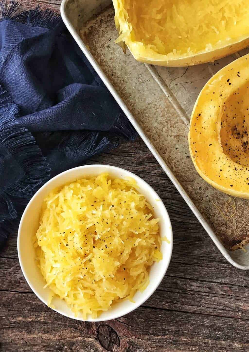 Spaghetti squash shown in a white bowl after cooking.
