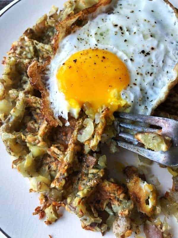 a hashbrown made in a waffle iron with a fried egg