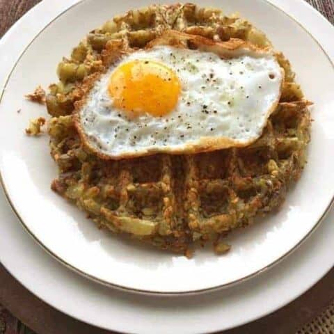 a hashbrown made in a waffle iron with an egg