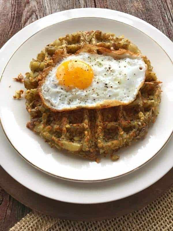 a hashbrown made in a waffle iron with an egg