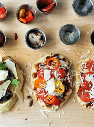 three naan pizzas with toppings