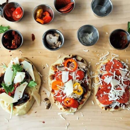three naan pizzas with toppings