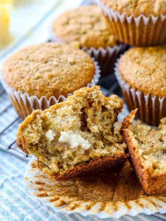 Bran muffins on a try with one in half with butter