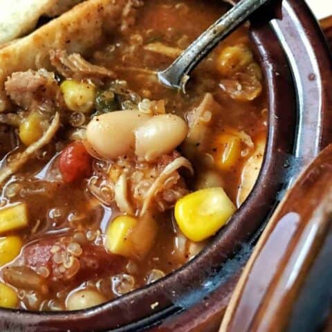 Chicken Tortilla Soup is a slow cooker dinner meal full of beans, quinoa, and vegetables. This soup comes together quickly with common items already in your pantry. A great use for leftover chicken.