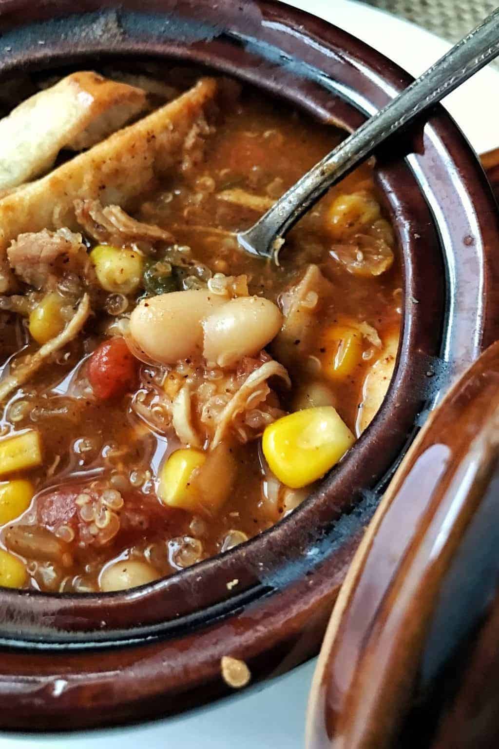 Chicken Tortilla Soup is a slow cooker dinner meal full of beans, quinoa, and vegetables. This soup comes together quickly with common items already in your pantry. A great use for leftover chicken.