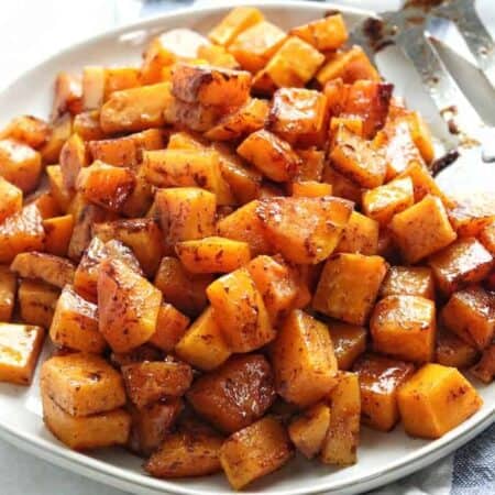 Caramelized butternut squash cubes on a plate.
