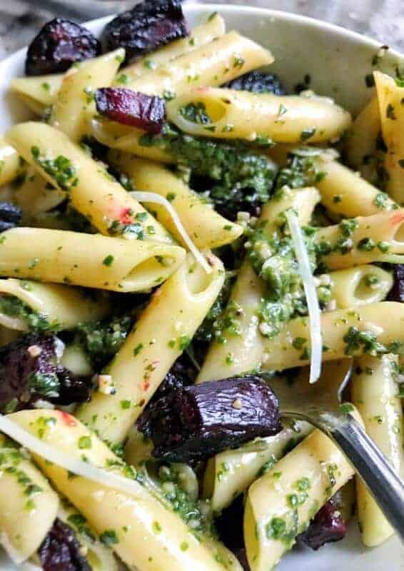 Beet green pesto served on pasta with roasted beets.