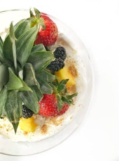 a top-down view of lemon curd triffle with a pineapple top and berries