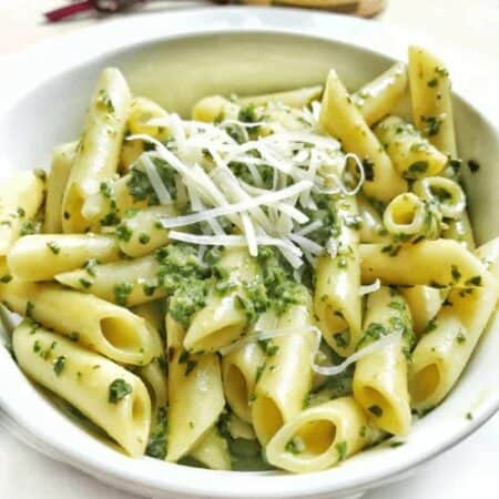 a bowl of pasta with pesto
