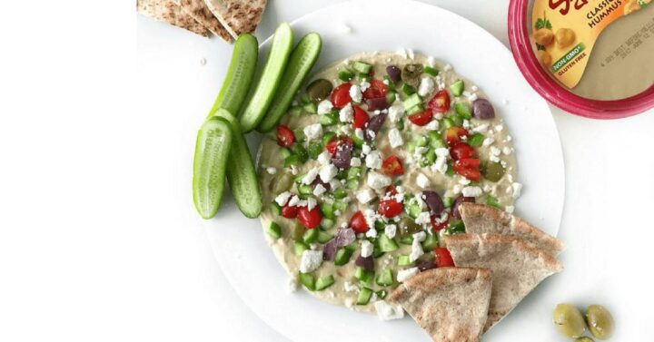 Quick & Easy Mediterranean Hummus Dip is a go to healthy appetizer that comes together in just 10 minutes. Using store-bought hummus, Greek yogurt, and lots of veggies, this simple snack is one you will make over and over. Yogurt adds even more creaminess to the hummus, while the veggies give this dip a fantastic flavor and crunch.