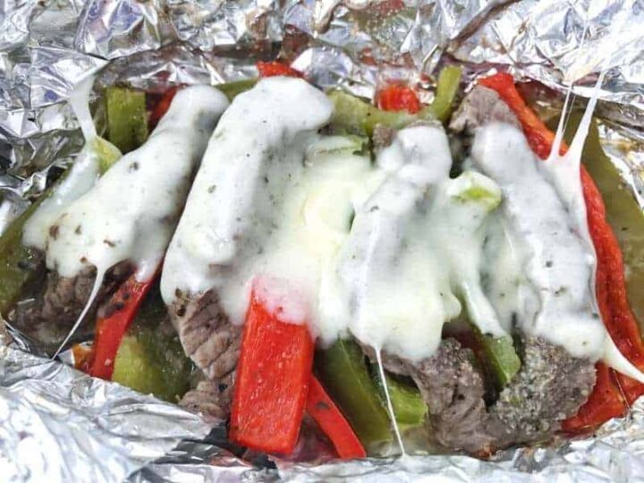 Cheese melted on top of steak and peppers
