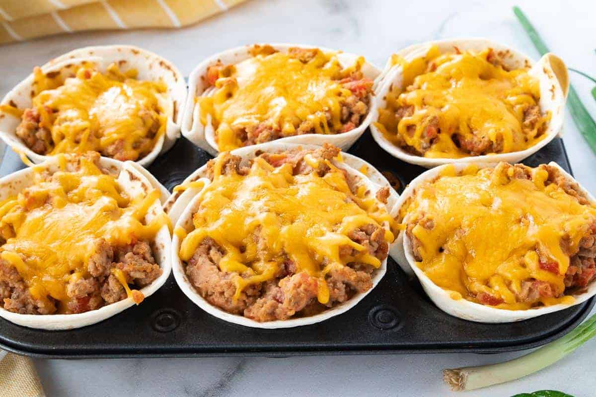 taco cups freshly baked with melted cheese on top of the taco cups.