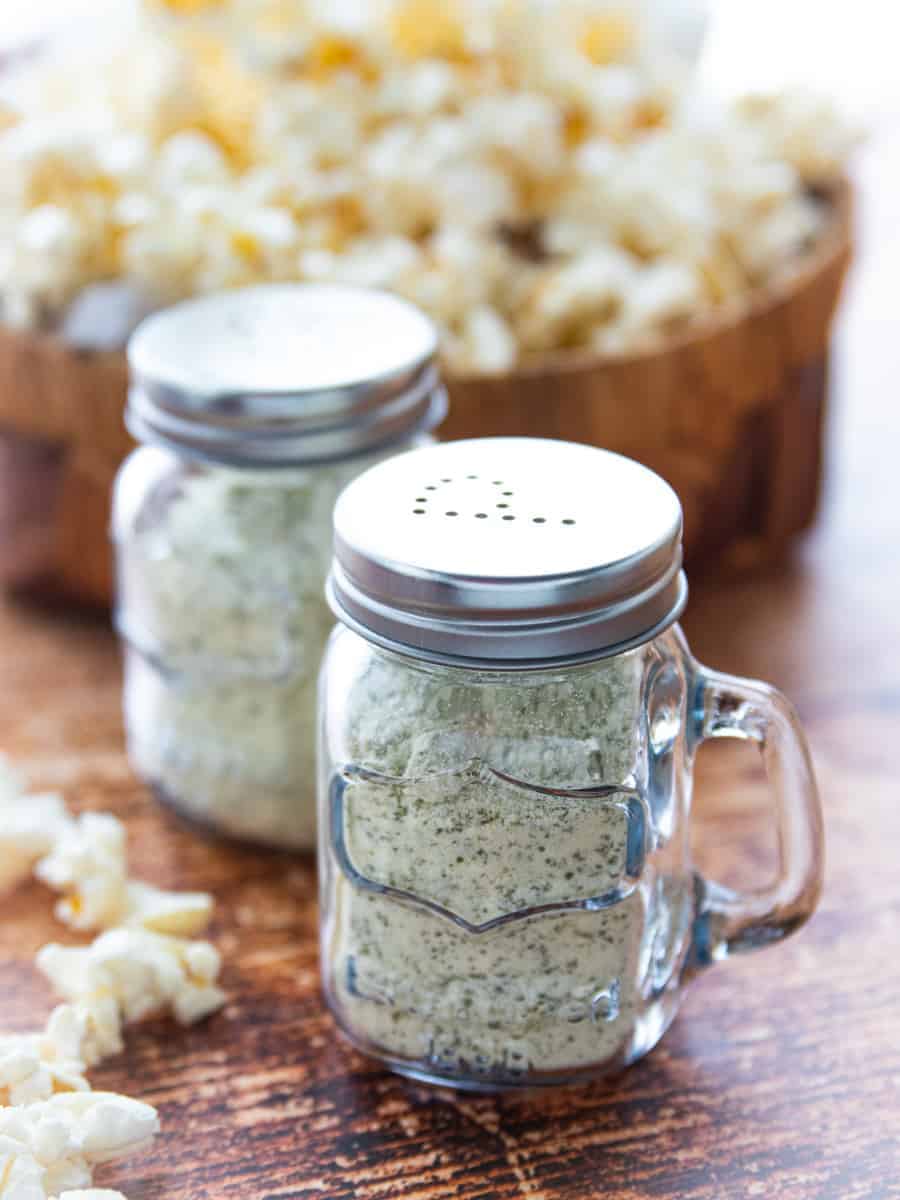 popcorn seasoning in a glass shaker