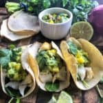 3 Baked Cod Fish Tacos with mango guacamole on top.