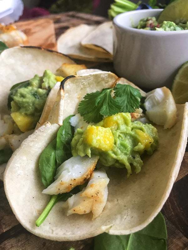 Baked Cod Fish Taco Recipe with holy moly guacamole, or a creamy guacamole perfect for fish tacos. This 20 minute family friendly dinner packs high flavor and vital nutrients your family needs.