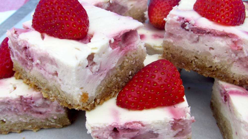 A close up of a slice of cake and ice cream on a plate, with Strawberry