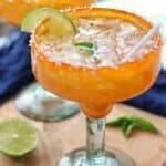 a margarita shown in an orange margarita glass.