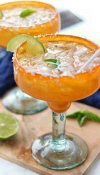 a margarita shown in an orange margarita glass.