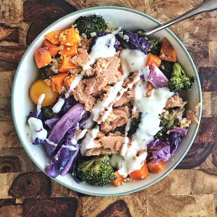 A leftover buddha bowl with tuna on top and ranch dressing.