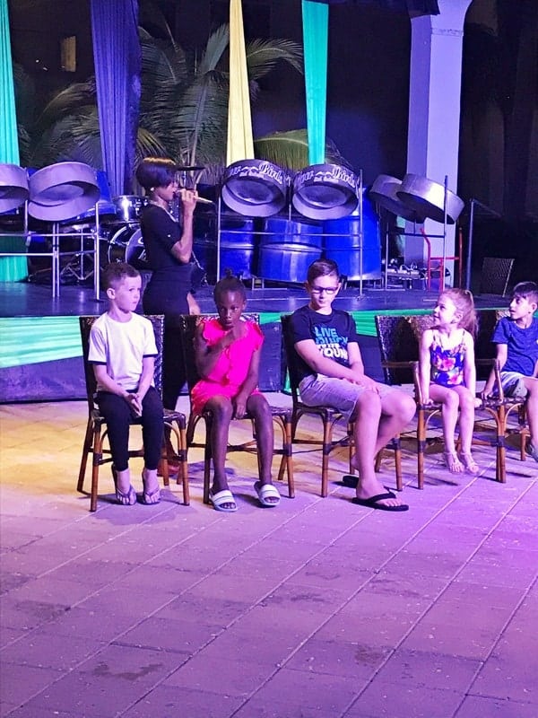 5 kids sitting in chairs participating in nightly entertainment at the Hilton Rose Hall in Jamaica.