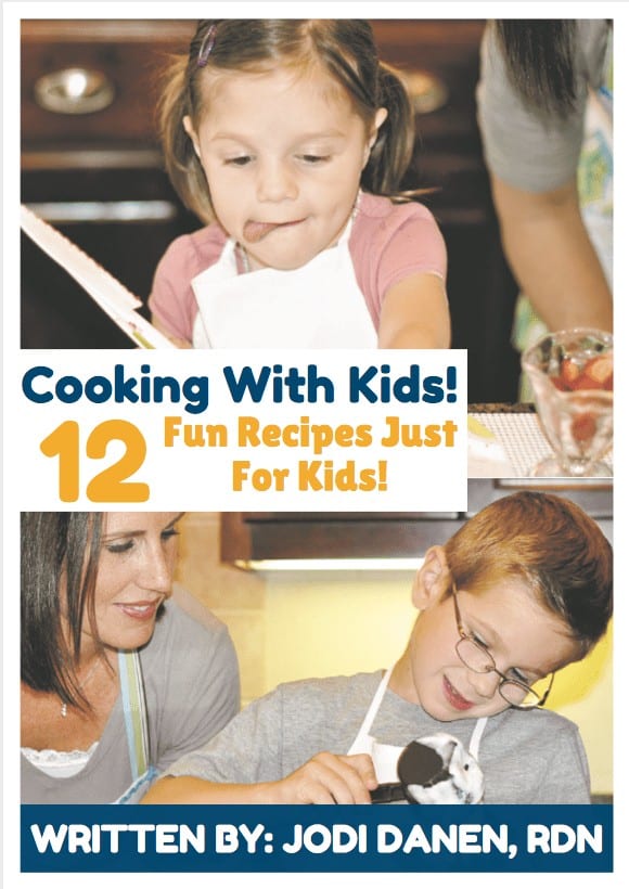 a mom and two kids cooking