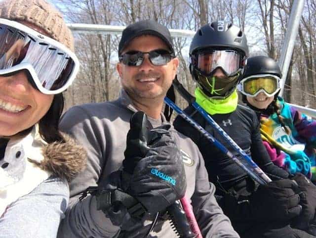 A group of people posing for the camera on a ski lift