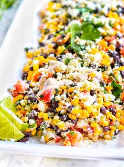 Mexican corn salad on a white serving tray