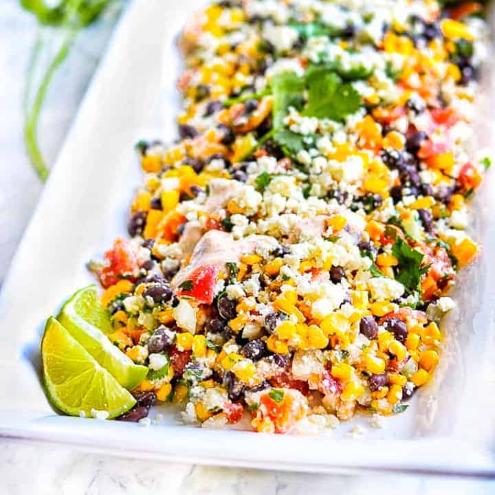 Mexican corn salad on a white serving tray