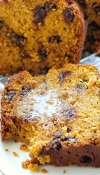 chocolate chip pumpkin bread on a plate with butter.