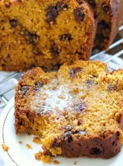 chocolate chip pumpkin bread on a plate with butter.