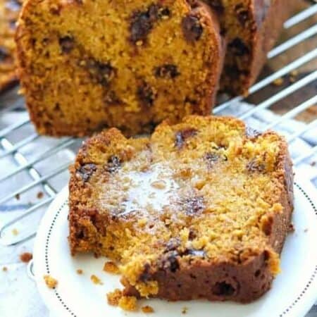 chocolate chip pumpkin bread on a plate with butter.