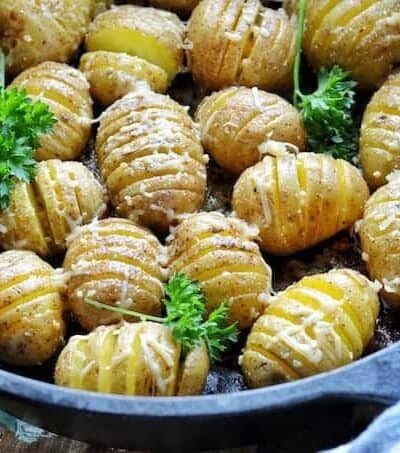 Hasselback potatoes in a skillet