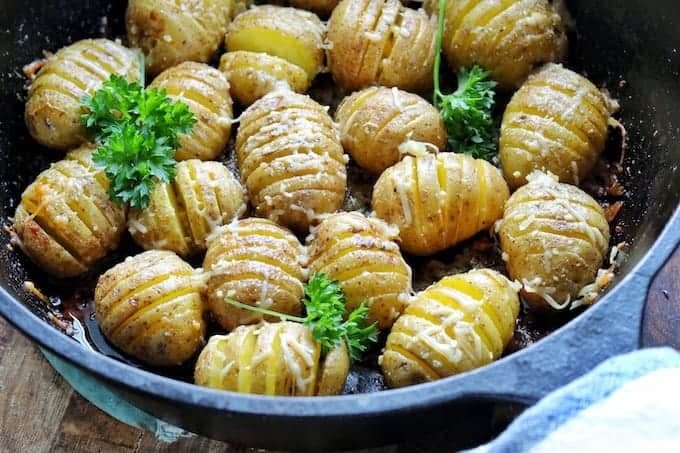 Hasselback potatoes in a skillet