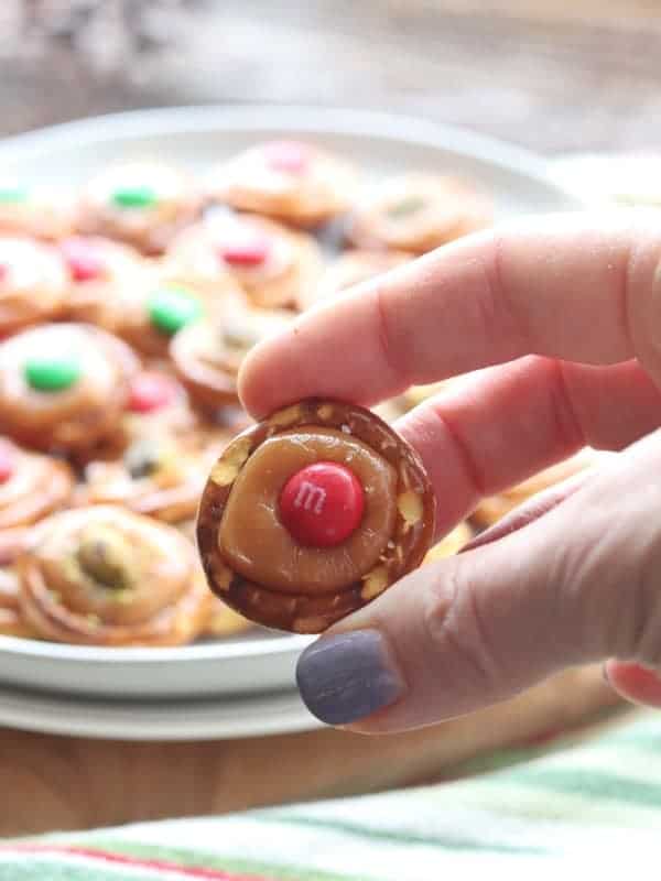 A person holding a Pretzel with Caramel