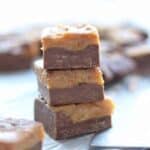 Peanut butter fudge slices shown stacked three high.