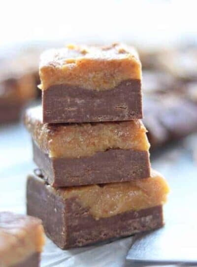 Peanut butter fudge slices shown stacked three high.