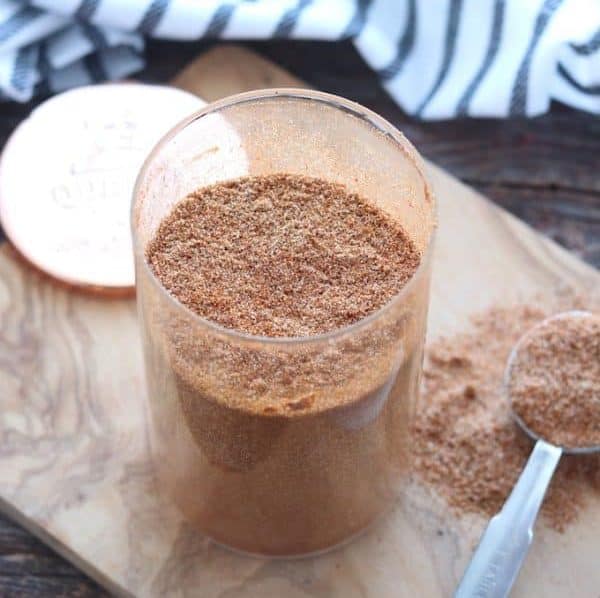 Taco seasoning in a glass jar on a table. 