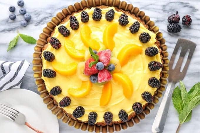 A cake with fruit on top of a table