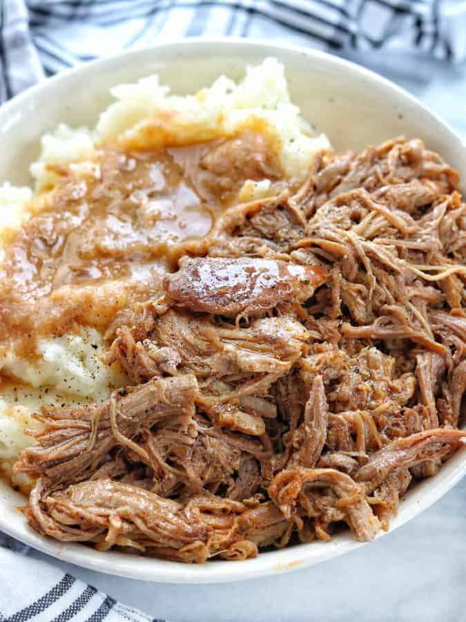 A plate full Pulled pork and mashed potatoes
