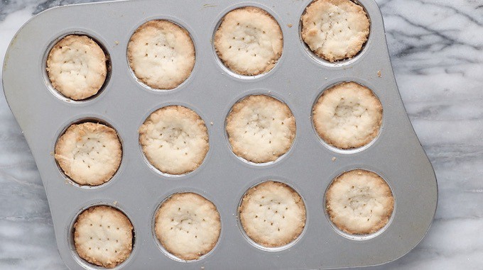 Mini tart crust shown baked in mini muffin pan.