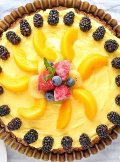 a fruit flan in a medal flutted pan