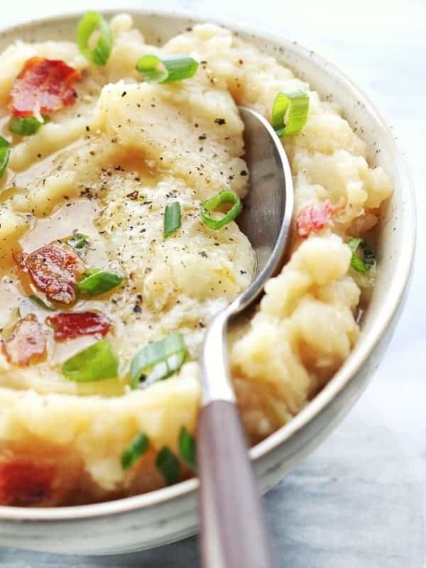 A close up colcannon with bacon and green onions