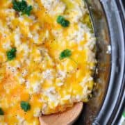 A close up of cheesy hashbrown potatoes in a crockpot