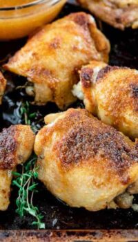 chicken thighs on a baking sheet after being broiled.