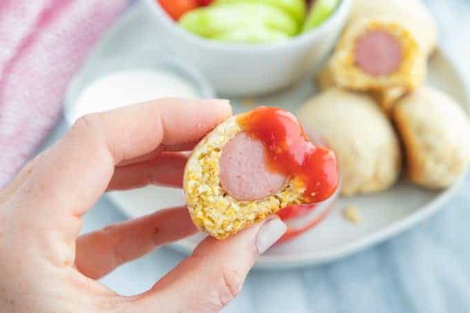 close up of a corn dog with ketchup